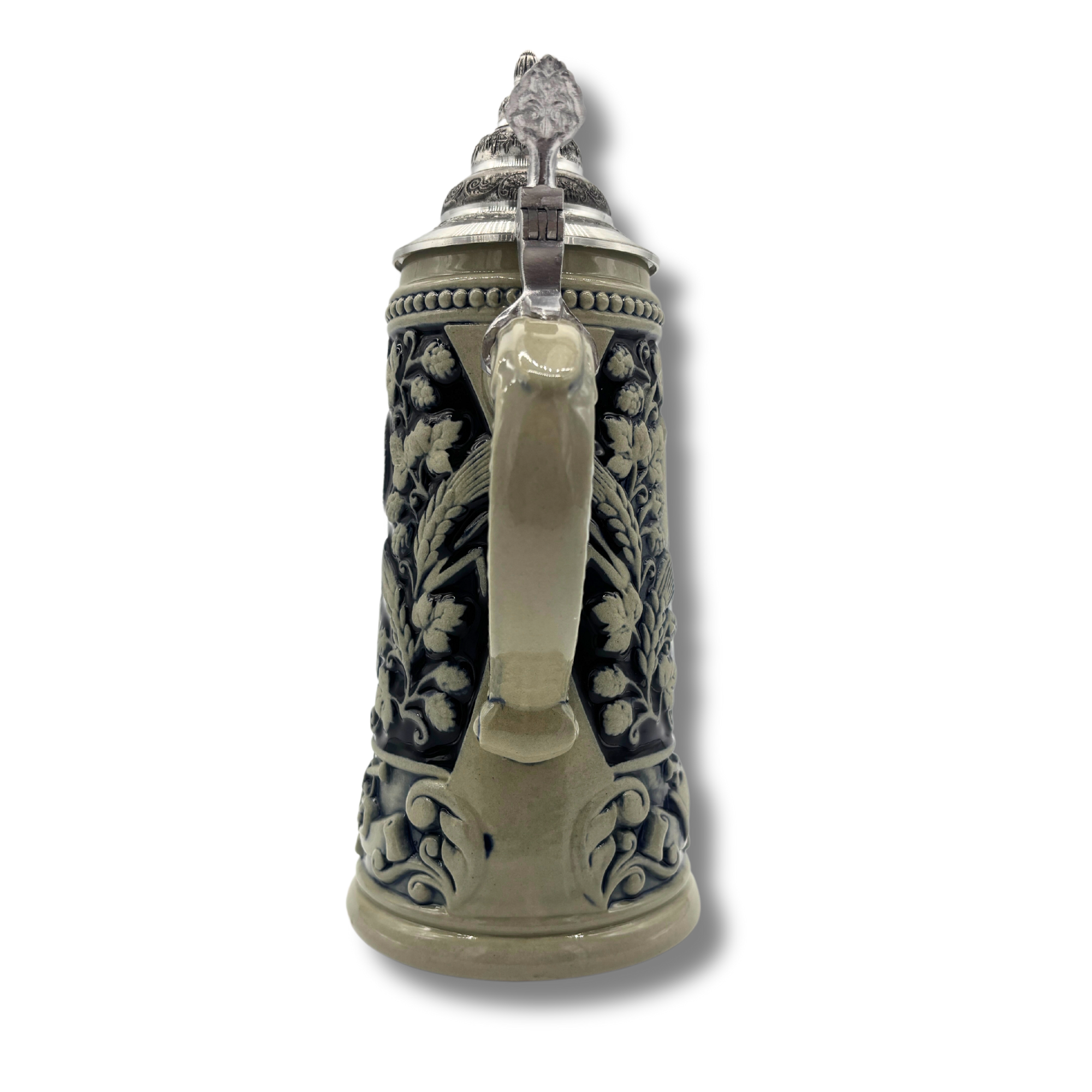 Reliefkrug mit Spitzzinndeckel, Relief in grau mit blauer Glasur, zeigt durchgehend das Hofbräuhaus München. Ansicht des Henkel, der formschön gestaltet ist und dekorative Elemente enthält